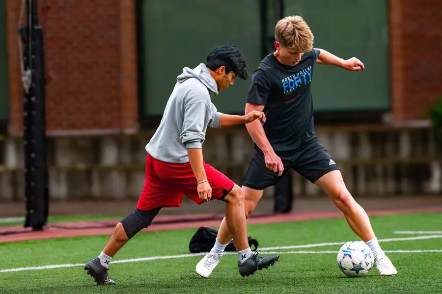 Soccer players battling for the ball