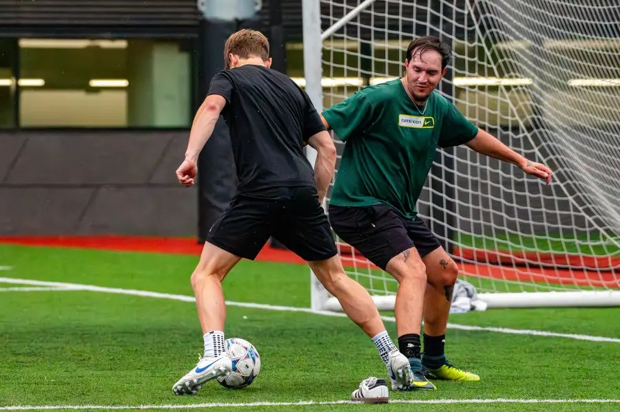Soccer players challenging in front of the goal