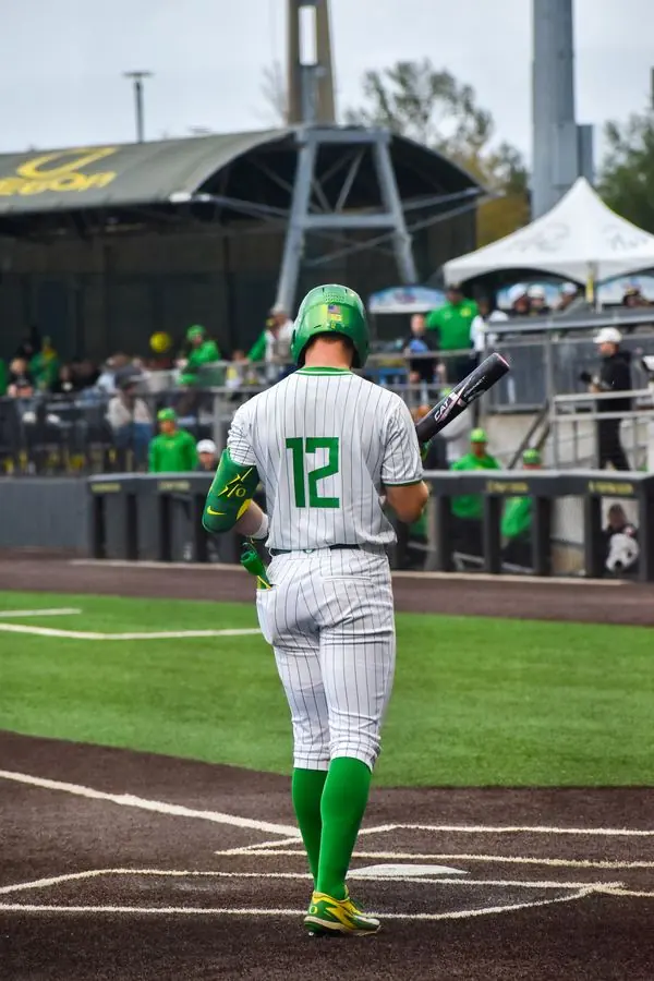 Oregon baseball player No. 12 walking to the plate