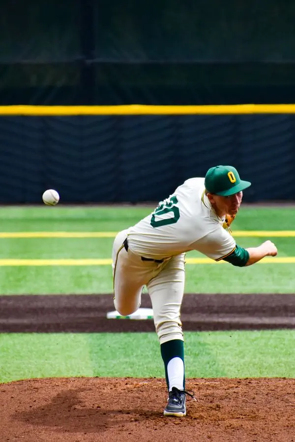 Oregon baseball pitcher mid-delivery
