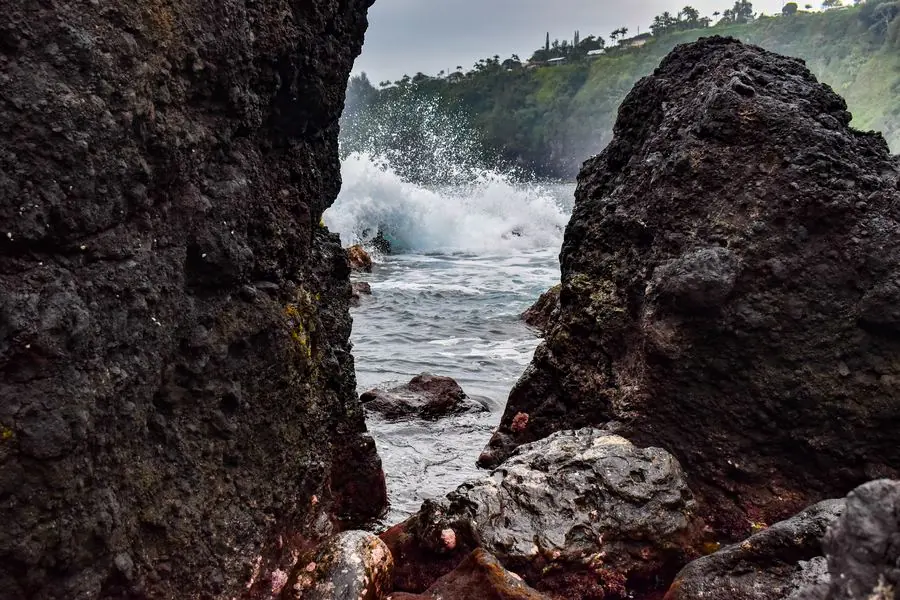 Waves crashing through volcanic rocks, Hawaii