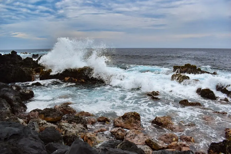 Waves breaking over a rocky Hawaiian shoreline