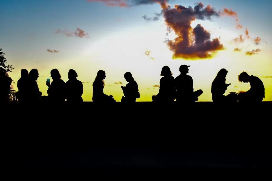 Silhouettes of people watching the sunset
