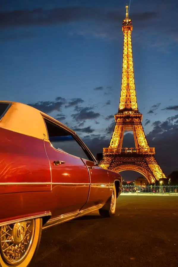 Classic car with the Eiffel Tower at night, Paris