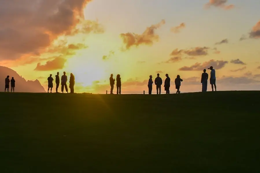 Group of people silhouetted watching the sunset
