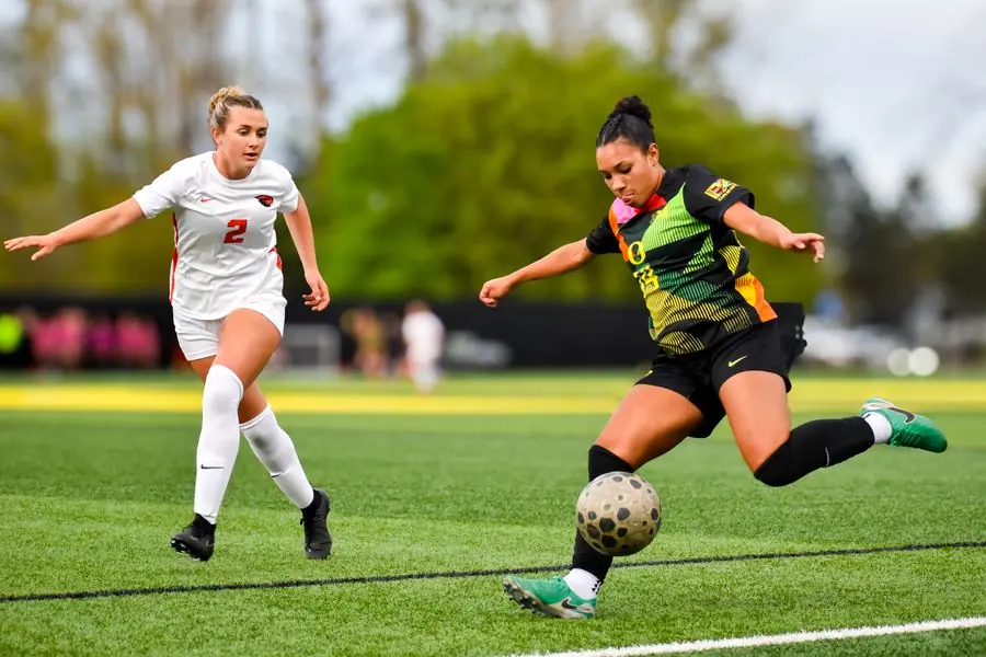 Oregon women's soccer player shooting against Oregon State