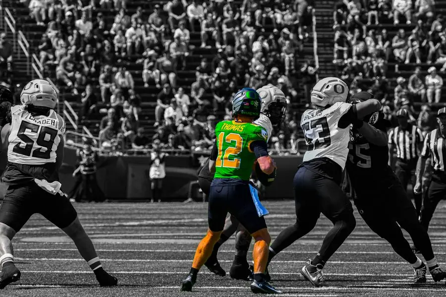 Oregon Ducks quarterback dropping back to pass, black and white