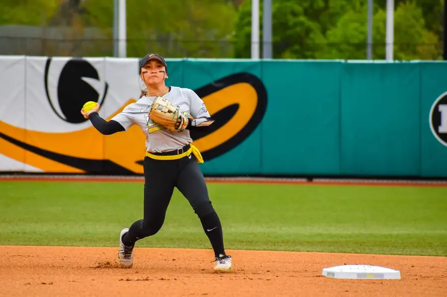 Oregon Ducks softball infielder throwing to first
