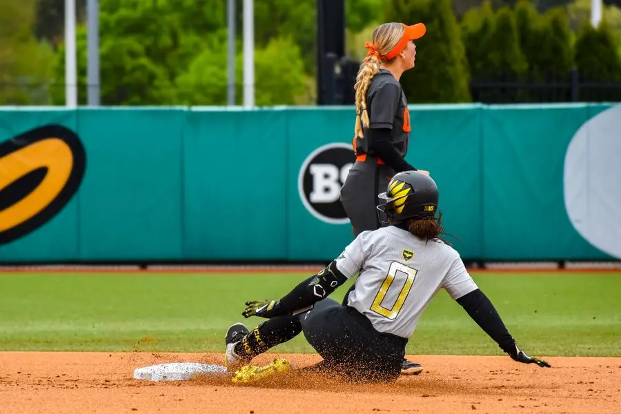 Oregon Ducks softball player sliding into second base