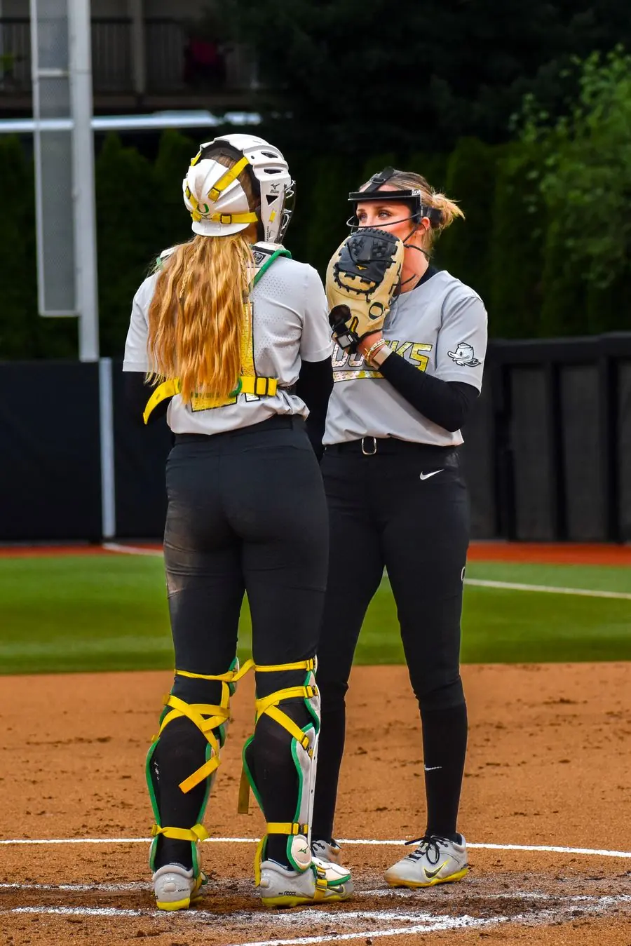 Oregon Ducks softball catcher and pitcher conferring at the mound