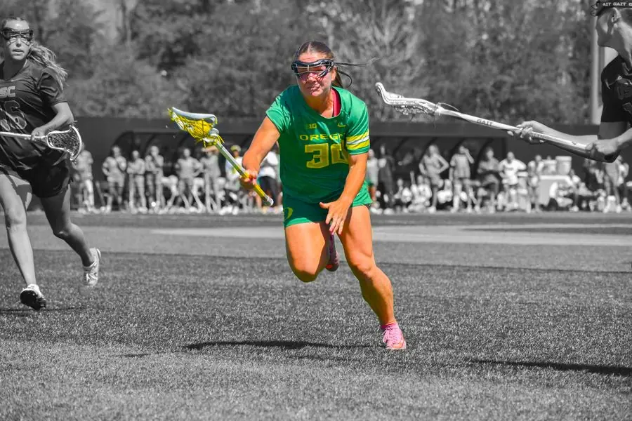 Oregon lacrosse player sprinting, black and white with color pop